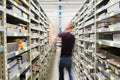 Metal shelves and technician at plant