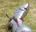 Metal shoes of a knight on the grass in nature