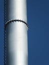 Metal silver industrial chimney against blue sky Royalty Free Stock Photo