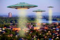 A metal and silver UFO invasion of planet Earth, a group of spaceships fly in the sky above the city and emit yellow rays to the