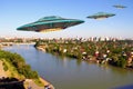 A metal and silver UFO invasion of planet Earth, a group of spaceships fly in the sky above the city and emit yellow rays to the Royalty Free Stock Photo