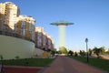 A metal and silver UFO invasion of planet Earth, a group of spaceships fly in the sky above the city and emit yellow rays to the Royalty Free Stock Photo