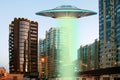 A metal and silver UFO invasion of planet Earth, a group of spaceships fly in the sky above the city and emit yellow rays to the Royalty Free Stock Photo