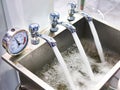 Metal sink with taps and manometer Royalty Free Stock Photo