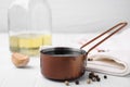 Metal small saucepan with balsamic vinegar and ingredients on white table Royalty Free Stock Photo