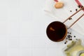 Metal small saucepan with balsamic vinegar and ingredients on white tiled table, flat lay. Space for text Royalty Free Stock Photo