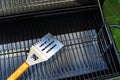 Metal spatula and grill grate. Equipment for cooking food on fire and charcoal. Close-up Royalty Free Stock Photo