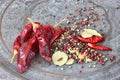 Metal spice grinder with red hot peppers and bay leaf Royalty Free Stock Photo