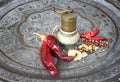 Metal spice grinder with red hot peppers and bay leaf Royalty Free Stock Photo