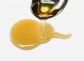 Metal spoon with a pouring drop honey Royalty Free Stock Photo