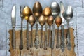 Metal spoons, forks, knives, on an old rustic table