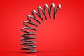 The metal spring bounces off the surface. Red background