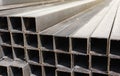 Metal square profile in a stack, metal pipes of square cross-section on the site of a building materials store, metal building