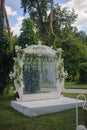 Metal square wedding arch decorated with pink and coral colored flowers anthurium, orchids and roses. Modern and unusual style,