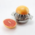 Metal squeezer with half grapefruit and orange Royalty Free Stock Photo