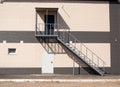 A metal staircase leading to the second floor along the outer wall of the building. fire escape Royalty Free Stock Photo