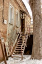 Metal staircase to climb to the second floor of an old brick building outdoors