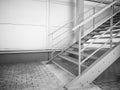 Metal stairs going up on the side of industrial building wall Royalty Free Stock Photo