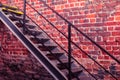 Metal stairway against old brick wall - vivid photo