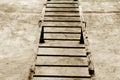 Metal stairway on cement wall in brown tone.