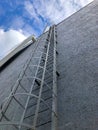 Metal stairway staircase at modern building exterior. Ladder leading to blue sky Royalty Free Stock Photo