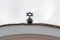 Metal Star of David on local synagogue roof top Royalty Free Stock Photo