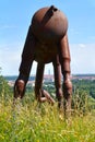 Metal statue of camel in the Prague Botanical Garden with the view of the Prague cityscape in the distance