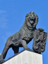 Metal statue of a lion with a symbol and emblem of Slovak statehood in Bratislava, Slovakia