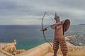 Metal statue of Medieval archer shooting bow