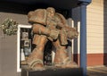 Metal statue of a surrealistic space marine holding his weapon outside a business in historic downtown Grapevine, Texas.