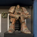 Metal statue of a surrealistic space marine holding his weapon outside a business in historic downtown Grapevine, Texas.