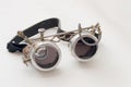 Metal steampunk glasses, google on white background, close up