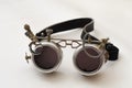 Metal steampunk glasses, google on white background, close up