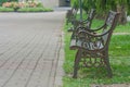 Metal steel old fashioned bench chair on green grass. Royalty Free Stock Photo