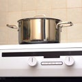 Metal steel saucepan on modern kitchen electric stove Royalty Free Stock Photo