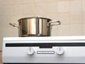 Metal steel saucepan on modern kitchen electric stove Royalty Free Stock Photo