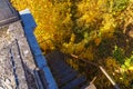 Metal steps of an old iron staircase of an emergency exit from the roof and a beautiful view of the nature of autumn