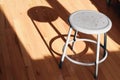 Metal stool on wood floor in room Royalty Free Stock Photo