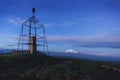 metal structure is the designation of a high point in the area on an early summer morning in a light misty haze. View of Elbrus. Royalty Free Stock Photo