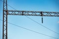 Metal structure high voltage transmission tower against a blue sky Royalty Free Stock Photo