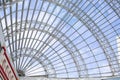 A metal structure supporting the supermarket glass dome. Transparent ceiling letting in sunlight, glass dome blue sky. Modern Royalty Free Stock Photo