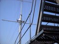 Metal structures on the deck of a warship. Aerial or mast mast with a round antenna. Steel cables and stairs. Water transport