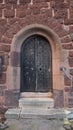 Metal studded weathered wooden door to an old church Royalty Free Stock Photo