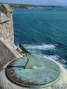 Sundial on a castle wall by the ocean Royalty Free Stock Photo