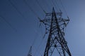 metal support of a high-voltage transmission line with strands of wires on a blue sky background Royalty Free Stock Photo