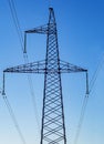 Metal support for power transmission lines 110/35/10 kV with wires and insulators against a blue sky. Royalty Free Stock Photo