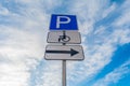 Metal support with traffic signs parking place, right signboard, sign of a place for the disabled against a blue sky