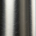 Metal surface with a brushed finish, displaying vertical linear patterns and light Royalty Free Stock Photo