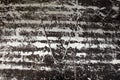 The metal surface is painted black, erased by stripes to a metallic silver sheen, with traces of scratches cracks and stripes. Royalty Free Stock Photo