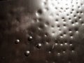 Metal surface with rivets and bolts. Abstract background of a military or industrial nature. Sheathing with dents, seams and nuts Royalty Free Stock Photo